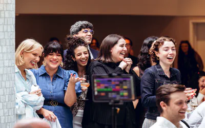 AUdience members on their feet to get closer and laughing at on stage antics.